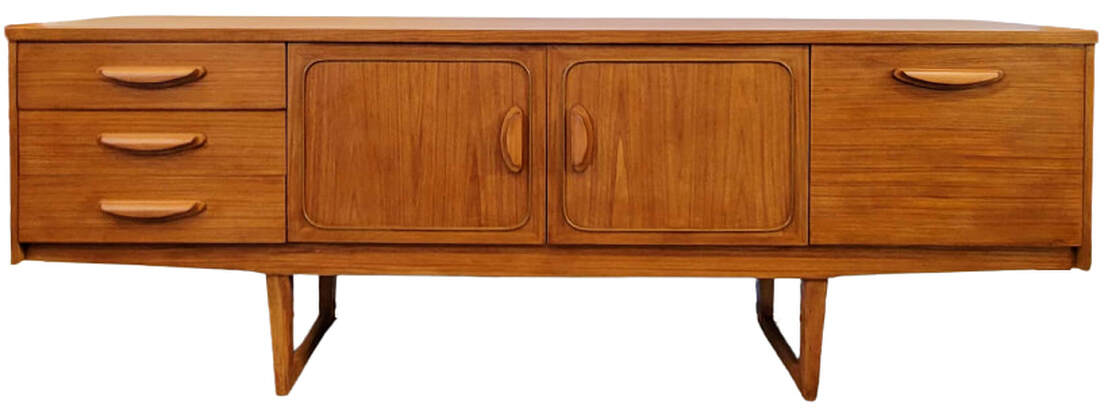 Stonehill Furniture teak credenza with sled legs is from the Stateroom Range, a line influenced by Danish Modern design.  Credenza is fitted with three drawers on the left; a double-doored cabinet at center with squircle cockbead panel framing; and a fall-front cocktail cabinet on the right.  Carcase is veneered with new growth Southeast Asian teak wood. The top, sides, and central cabinet doors feature crown-cut teak.  80.5