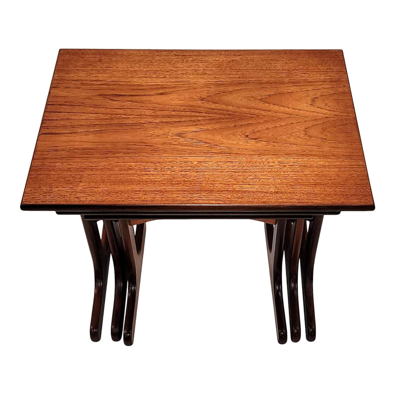 Set of three nested tables produced by the Ebenezer Gomme ( E. Gomme ) furniture company in High Wycombe, England, for their G-Plan brand.  Manufactured with reddish-brown African afrormosia wood trim and legs and lighter southeast Asian teak for the table tops and curved stretchers.
