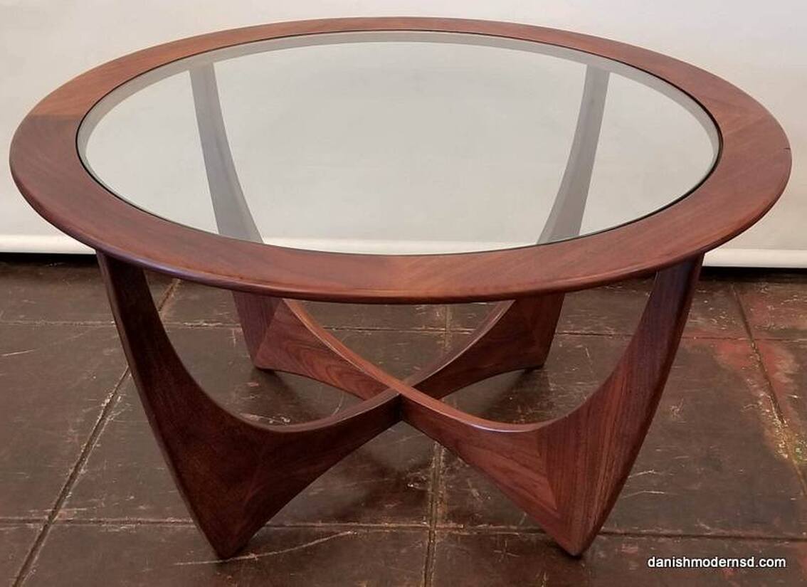 Mid-Century Modern glass-topped circular cocktail table with African afrormosia wood base.