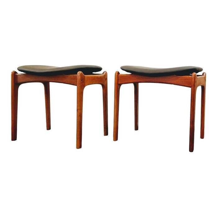 Eric Buch designed stools in teak wood with a black floating saddle seat. Designed about 1949.